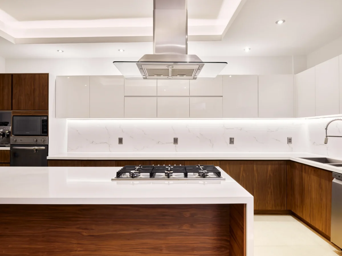 Cocina a la medida con isla, campana integrada y frentes de madera